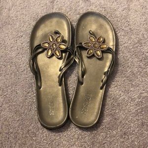 Gray sandals with flower detail.